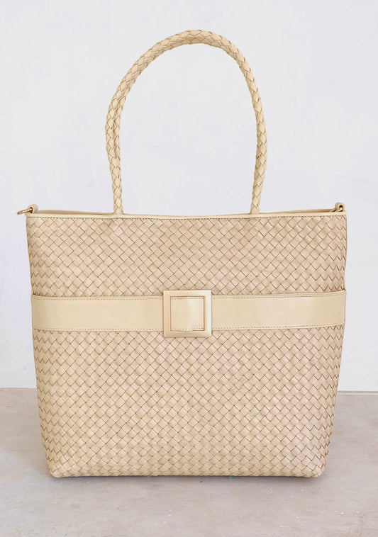 Sustainable Italian leather designer handbag, medium tote and crossbody in cream. Handbag with accent buckle that is a functional work of art.