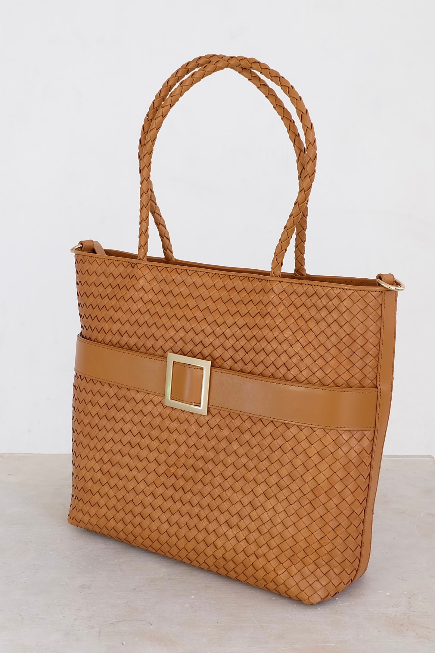 Sustainable Italian leather designer handbag, medium tote and crossbody in cognac brown. Handbag with accent buckle that is a functional work of art.