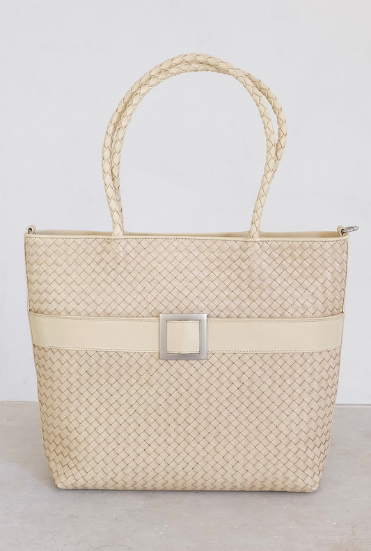 Sustainable Italian leather designer handbag, medium tote and crossbody in cream. Handbag with accent buckle that is a functional work of art.
