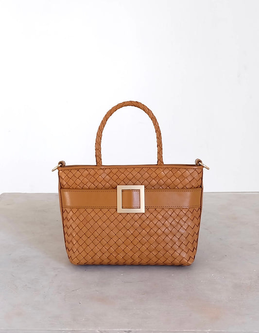 Sustainable Italian leather designer handbag, mini tote and crossbody in cognac brown. Handbag with accent buckle that is a functional work of art.
