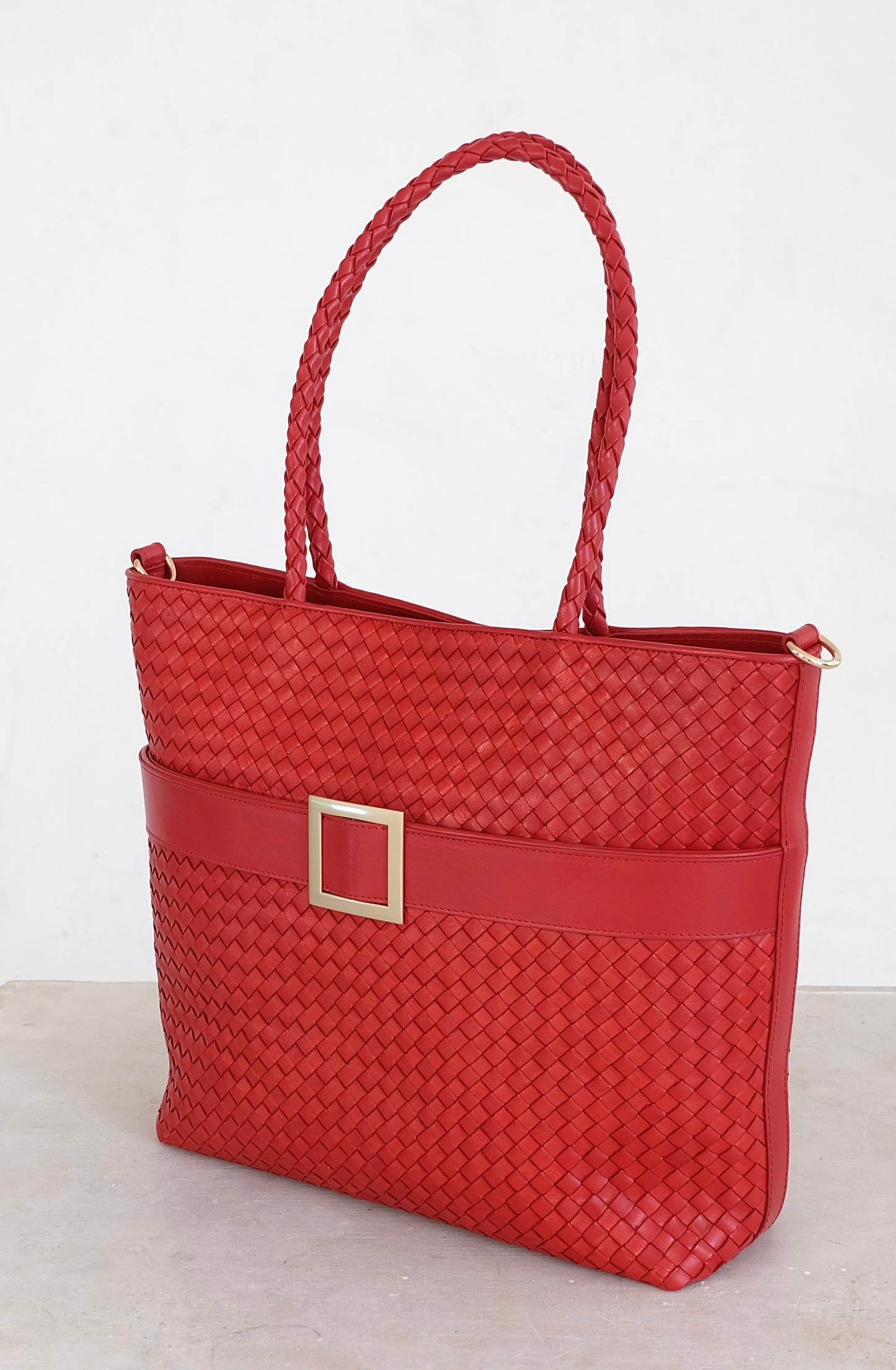 Sustainable Italian leather designer handbag, medium tote and crossbody in chili red. Handbag with accent buckle that is a functional work of art.