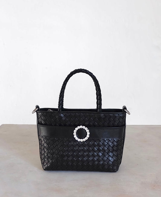 Sustainable Italian leather designer handbag in charcoal black. Braided mini tote bag and crossbody in one, with accent buckle and front compartment.