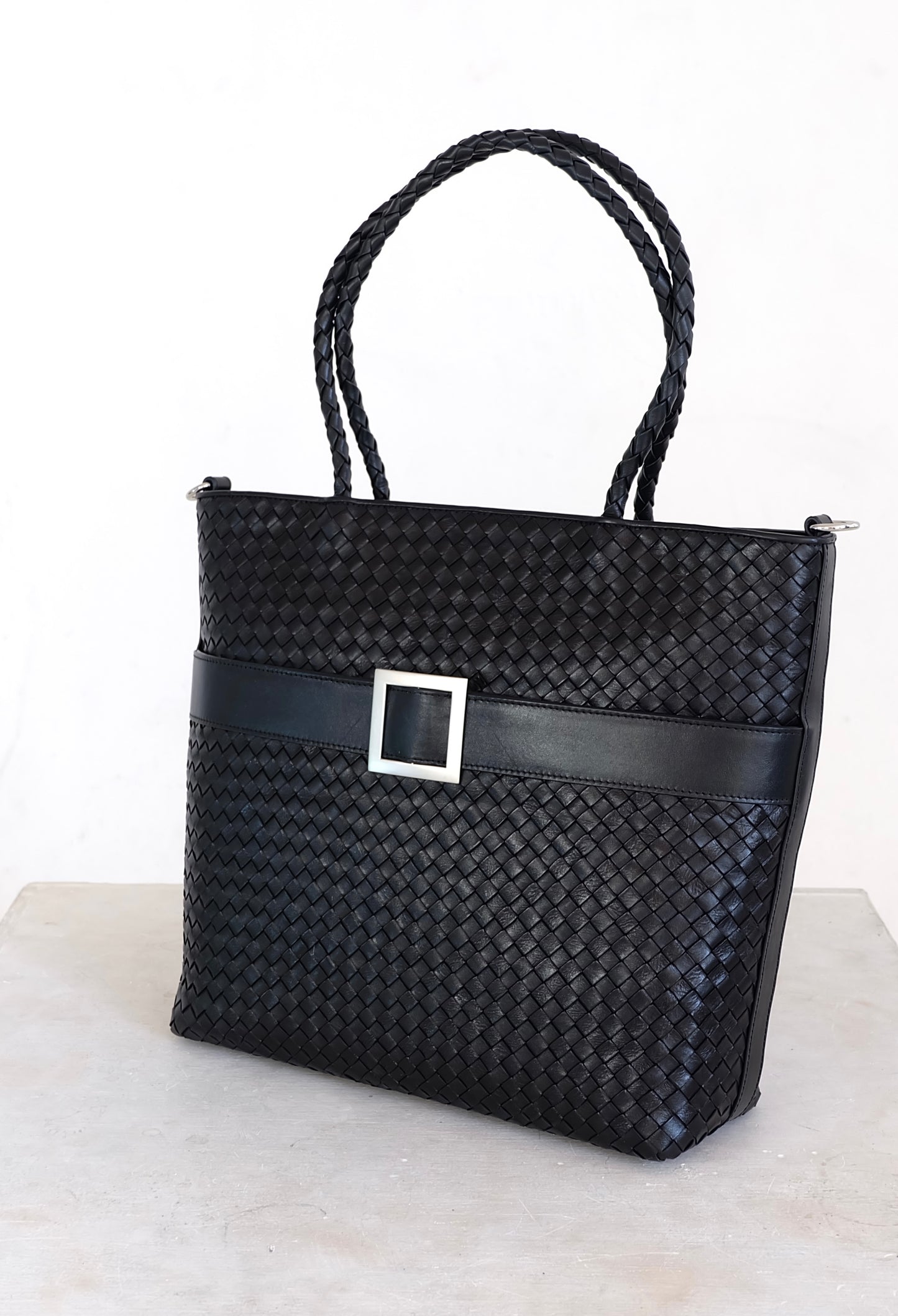 Sustainable Italian leather designer handbag, medium tote and crossbody in charcoal-black. Handbag with accent buckle that is a functional work of art.